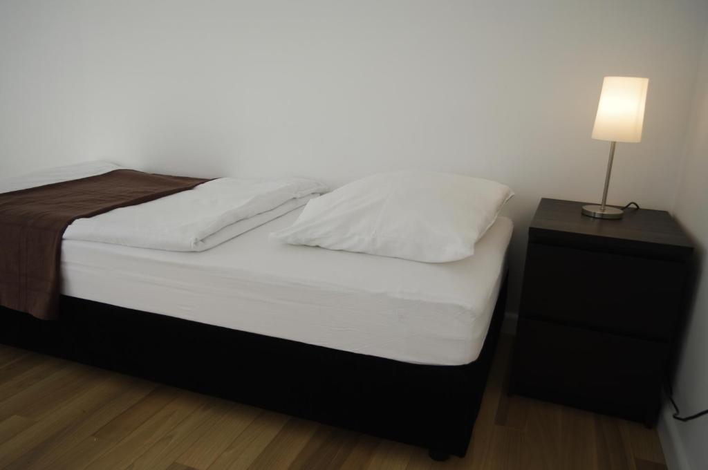 Postel nebo postele na pokoji v ubytování Apartments Santis10
