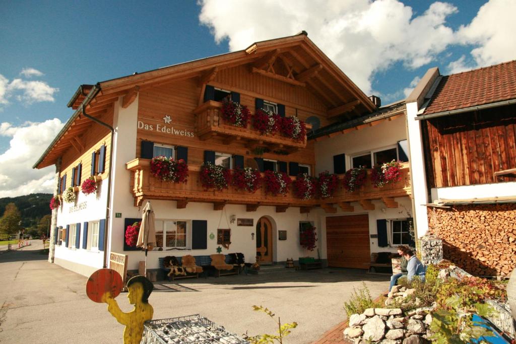 a building with flower boxes on the side of it at Das Edelweiss in Grän