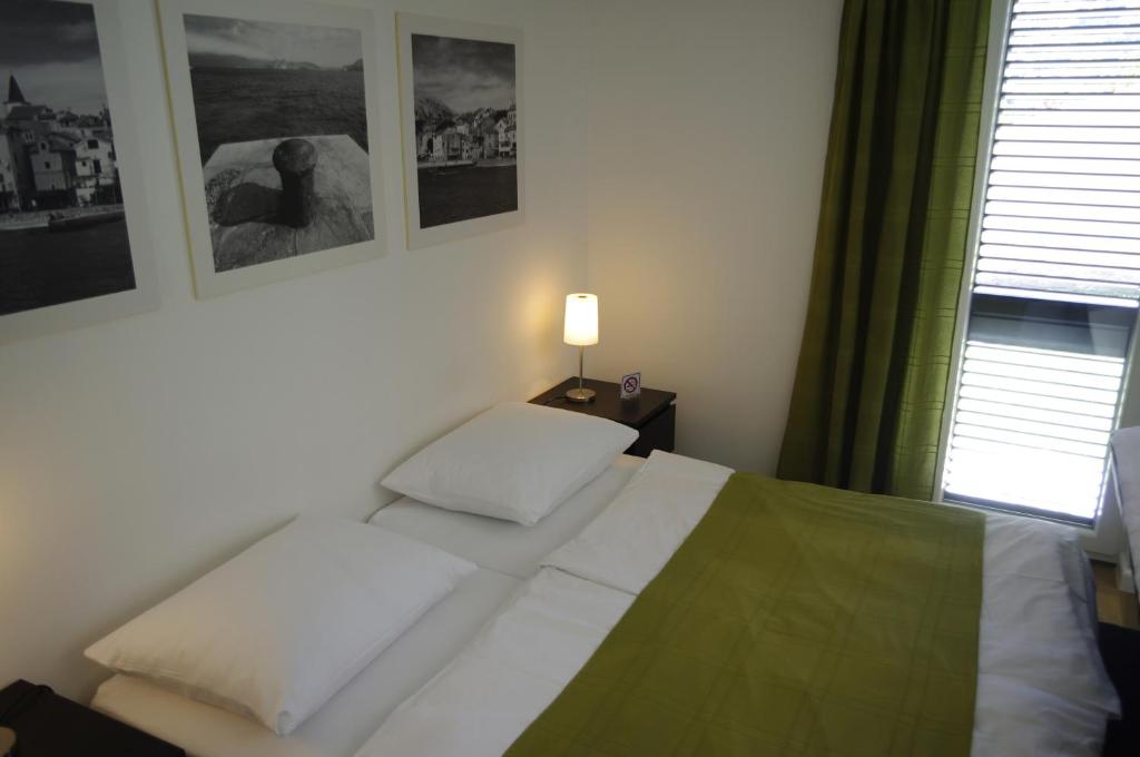 Postel nebo postele na pokoji v ubytování Apartments Santis10