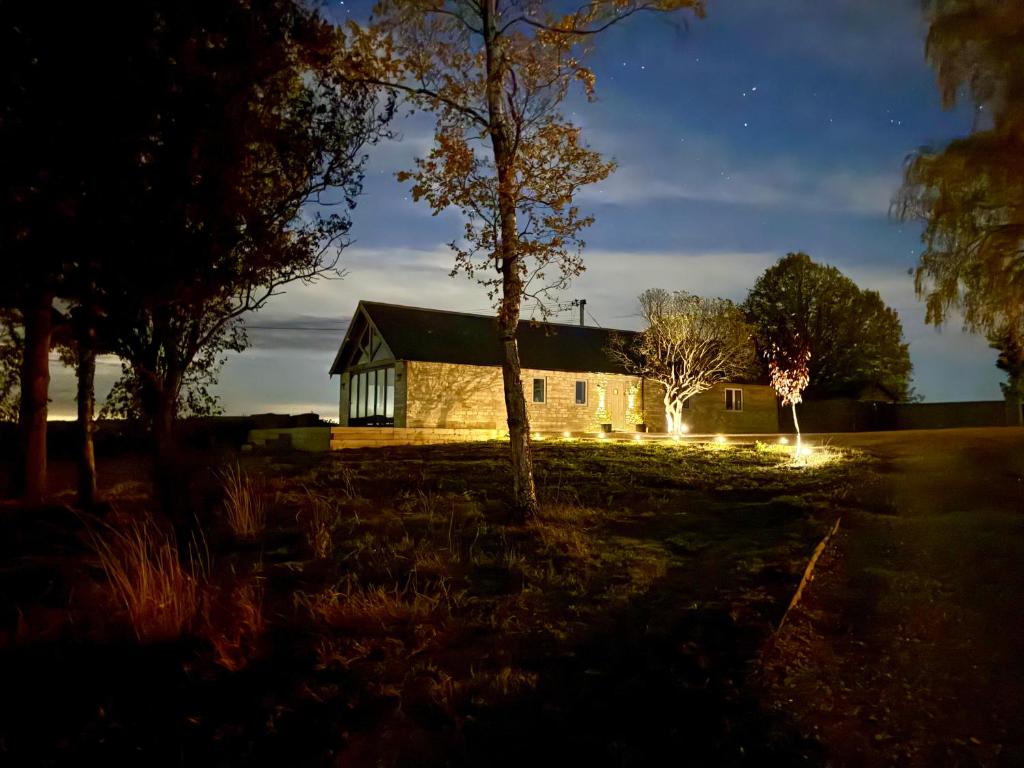 a house at night with lights in front of it at Serene Cotswold Escape 360 Views Private Acres Dog Friendly in Halford
