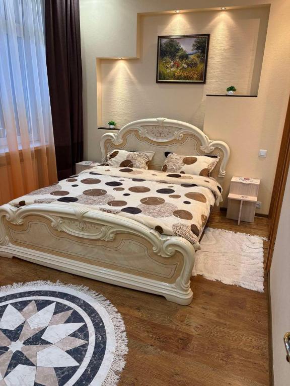 a bedroom with a large white bed with pillows at Найкраща Квартира in Kamianets-Podilskyi