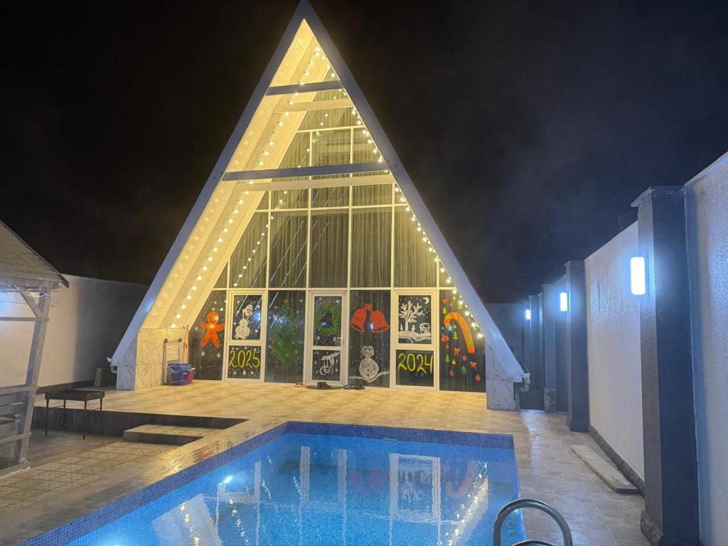 a church with a swimming pool in front of a building at bag evi in Mardakan