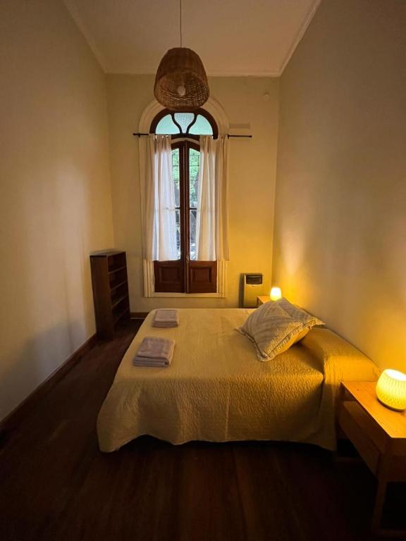 a bedroom with a large bed with a window at Casa Próspera in Buenos Aires