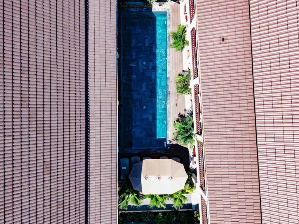 an overhead view of a swimming pool between two buildings at The Secret Luang Prabang in Luang Prabang