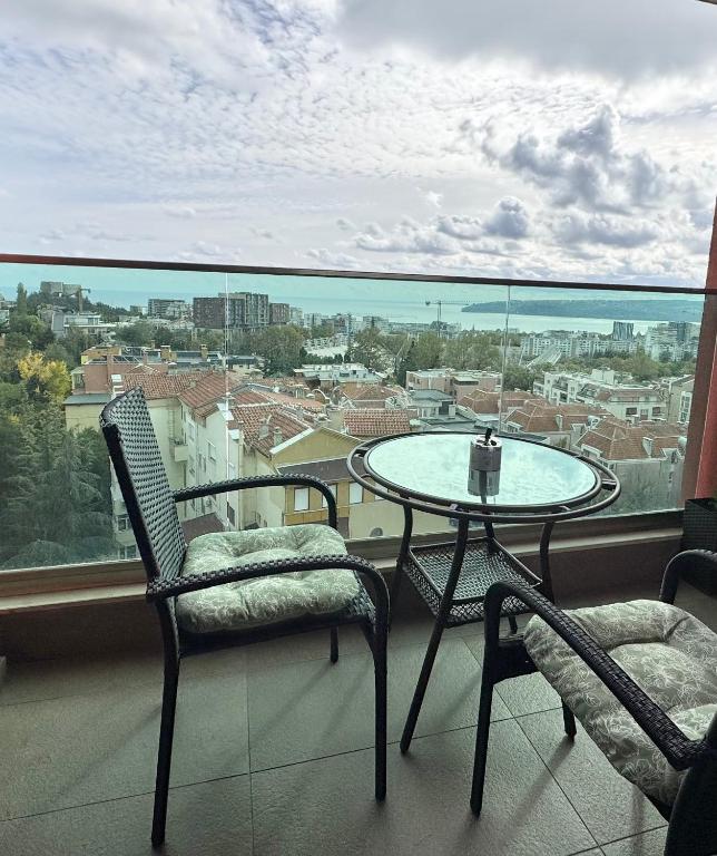 a balcony with a table and chairs and a view at Breathtaking sea view apartment in Varna City