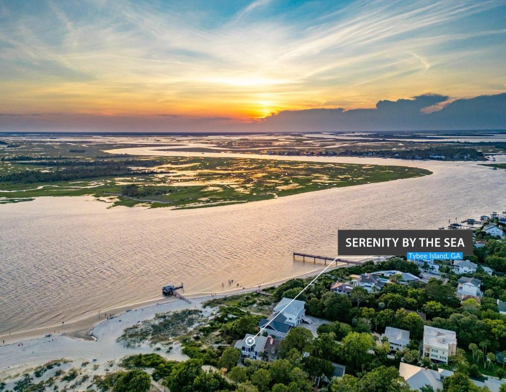 an aerial view of a beach at sunset at Serenity at the Sea in Tybee Island