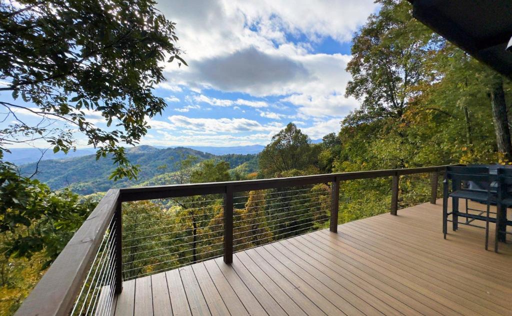 a wooden deck with a view of the mountains at Calling Me Home in Blowing Rock