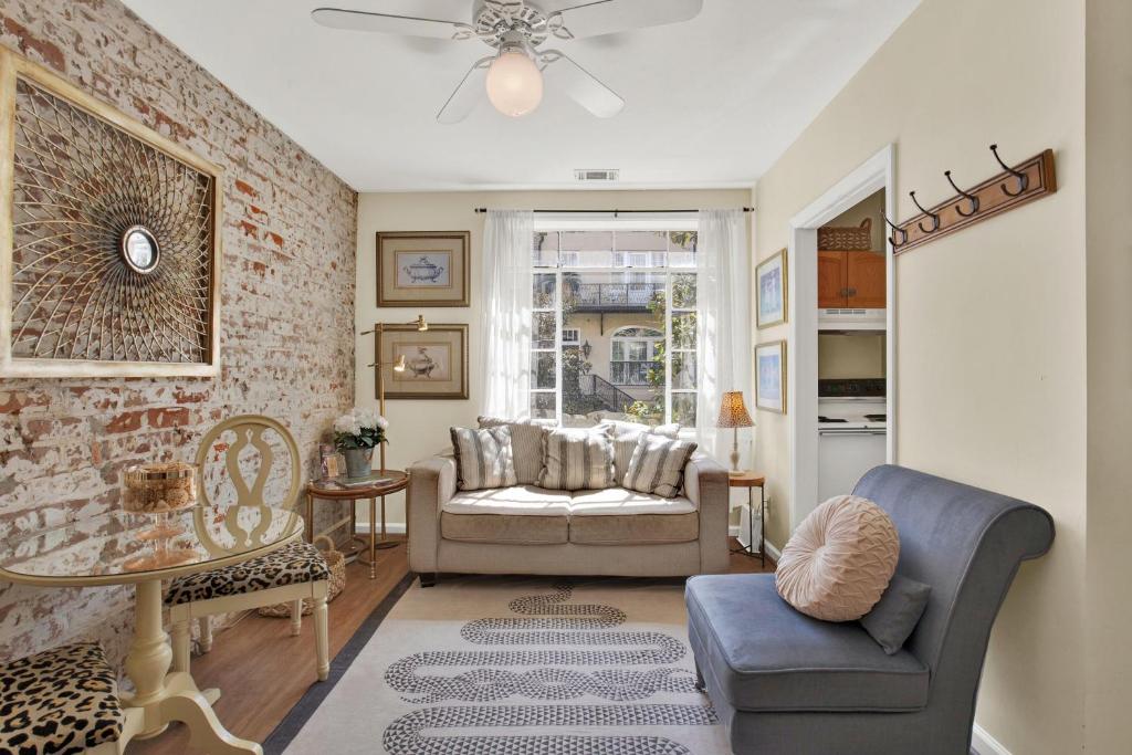 a living room with a couch and a chair at Above the Tea Room off Madison Square in Savannah