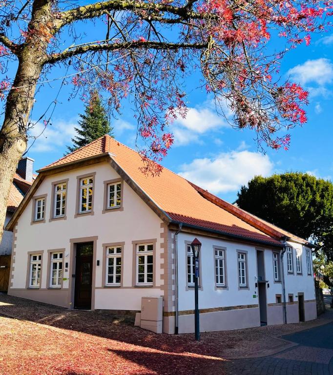 a white building with a red roof at Eibenhaus in Bad Iburg