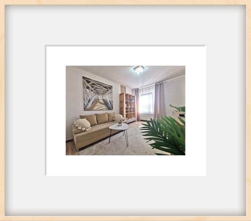 a living room with a couch and a table at Chillout Apart pod Górą Zamkową in Wleń