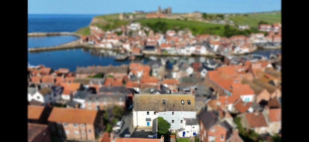 arial view of a town with buildings and the ocean at Lot 1 The Old Auction Room in Whitby