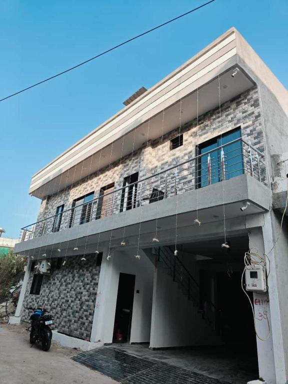 a building with a motorcycle parked in front of it at Shivay Adventure in Kevadia
