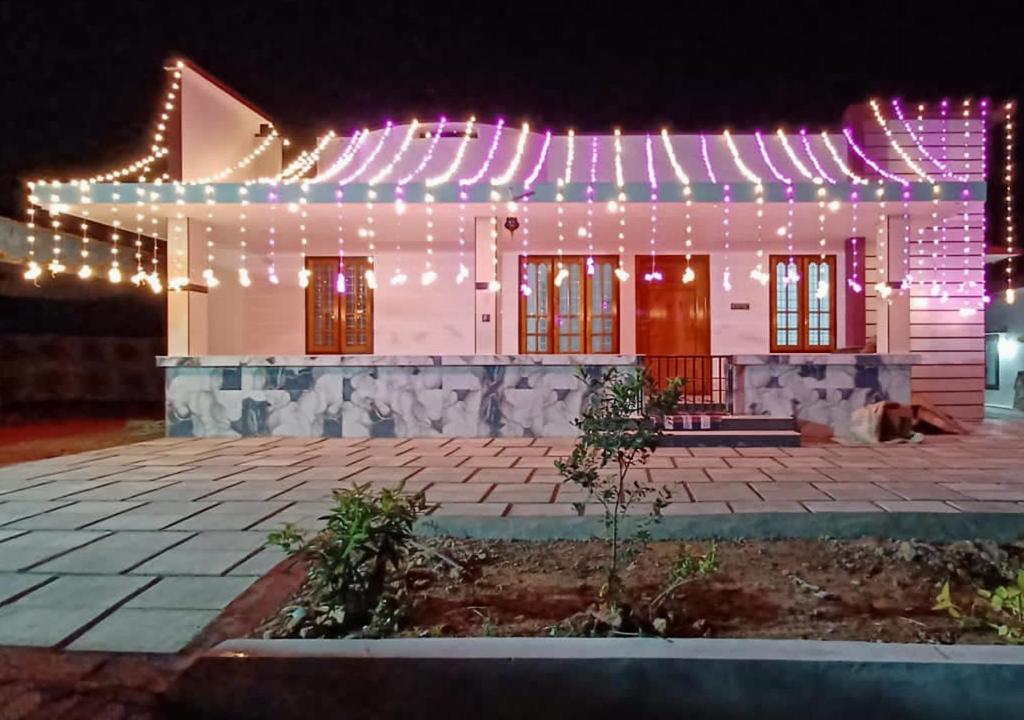 a house with christmas lights on the facade at Devas Homestay in Kallar-Bridge