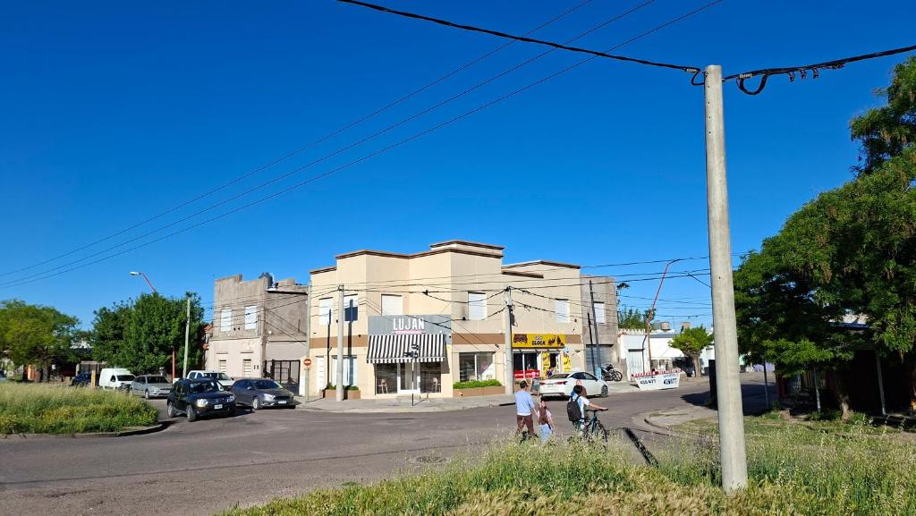 a group of people walking down a street at Departamentos céntricos con parrilla in Punta Alta