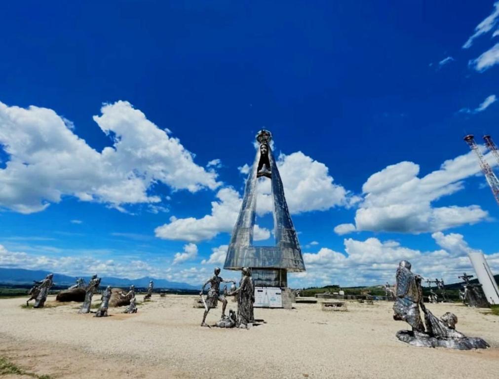eine Gruppe von Menschen steht um ein Denkmal in der Wüste in der Unterkunft Cantinho da Vovó in Aparecida