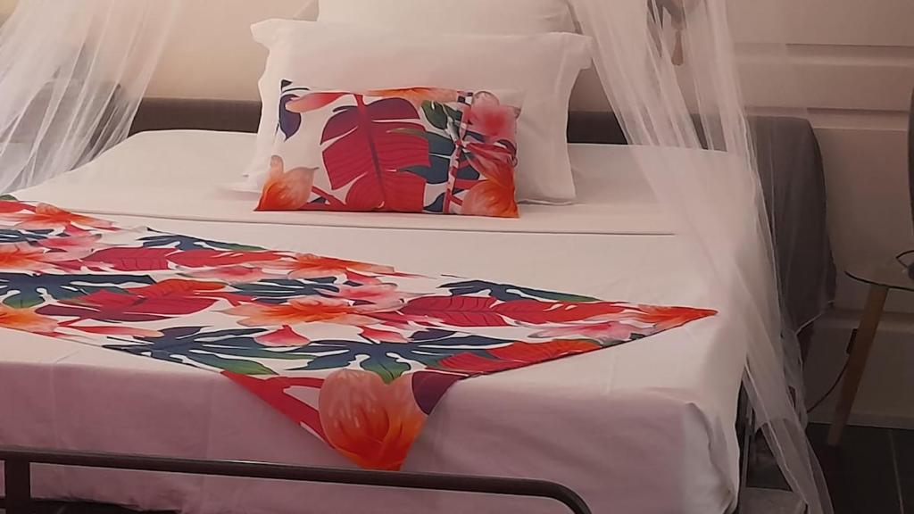 a bedroom with two bunk beds with a floral bedspread at Les hauts de bellevue in Bouillante
