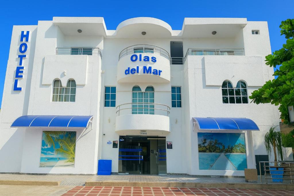 a white building with a sign that reads olgas del mar at Olas del Mar by GHO Hoteles in Santa Marta