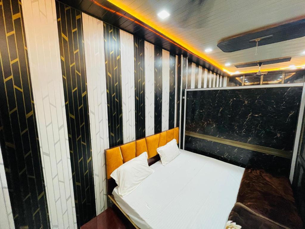 a small room with a white bed with two pillows at My Perfect Stay in Ayodhya