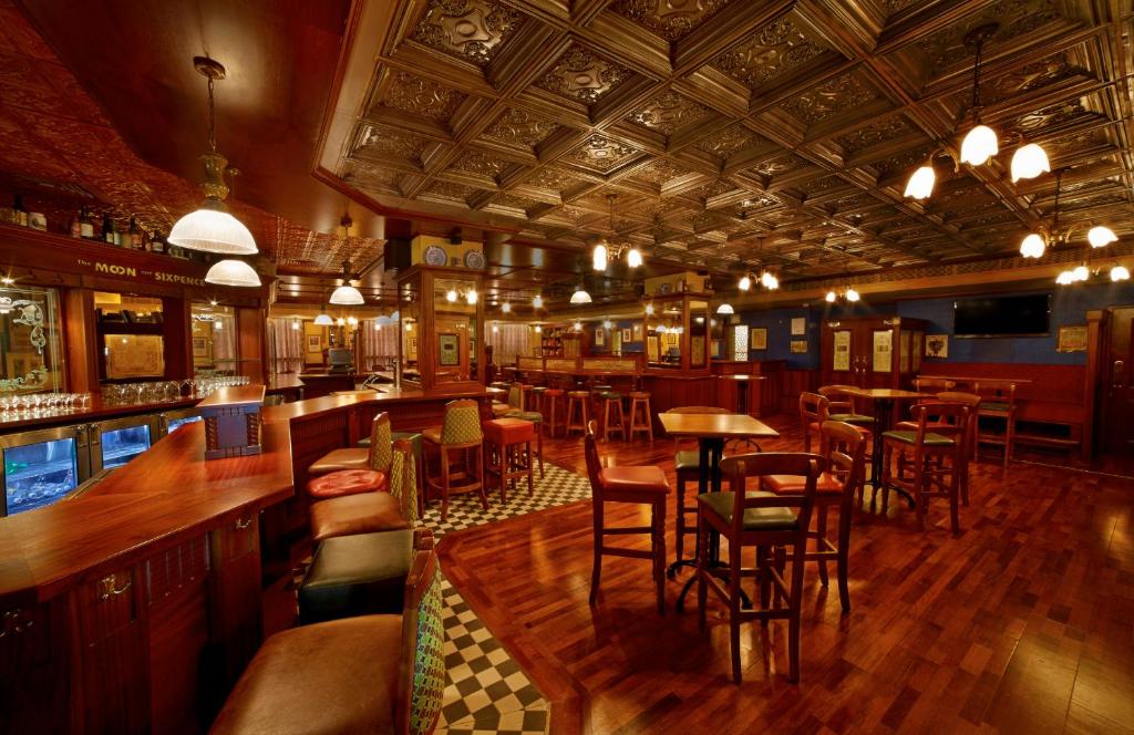 a bar with tables and chairs in a restaurant at Hablis Chennai in Chennai