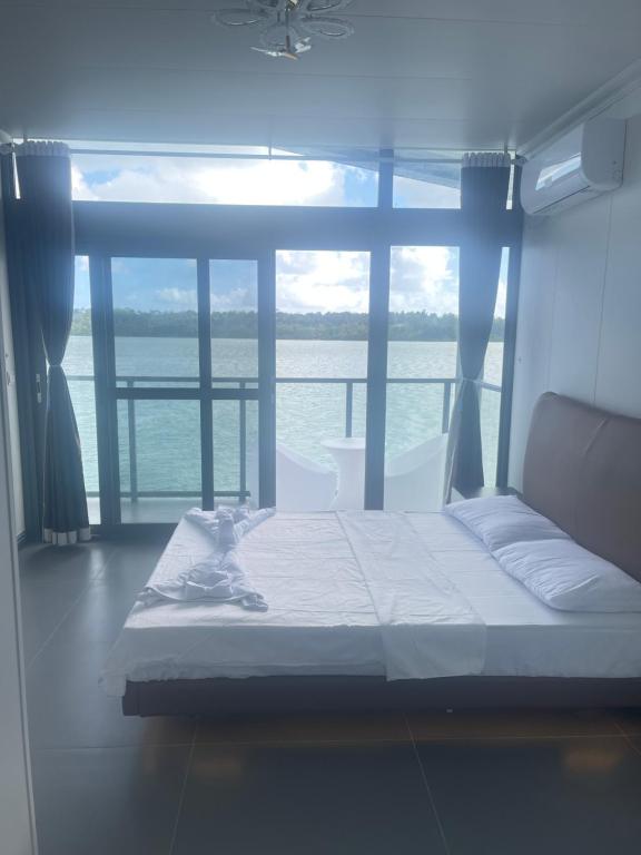 a bed in a room with a view of the ocean at lake view apartment 湖畔别墅 in Montmartre