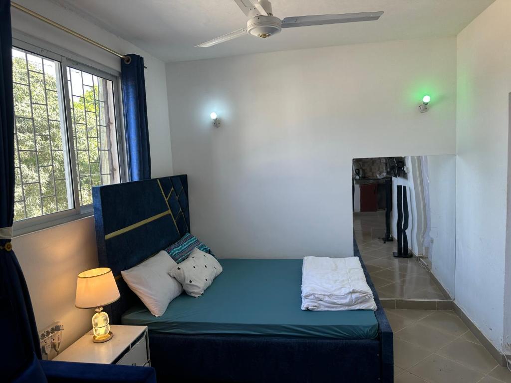 a living room with a blue couch and a window at Rent Mombassa Mtwapa Kenya 2people in Bardejov