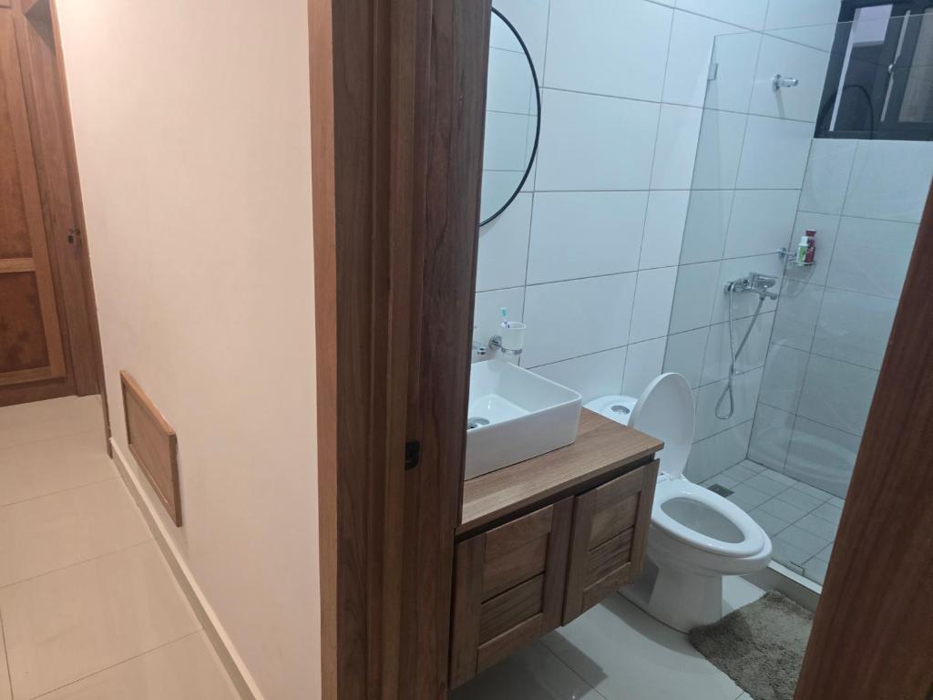 a bathroom with a sink and a toilet and a shower at Sunrise Apartments in San Felipe de Puerto Plata