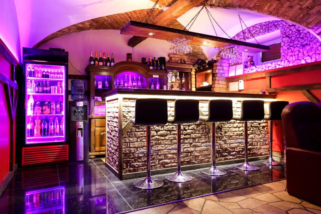 a bar with a stone wall with wine bottles at Riga Well Hotel in Riga