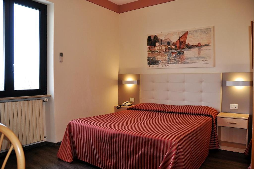 Postel nebo postele na pokoji v ubytování Hotel Panoramica