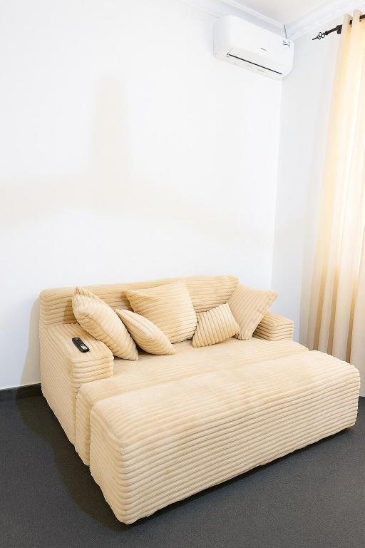 a white couch with pillows on it in a room at Zurihomes in Dar es Salaam