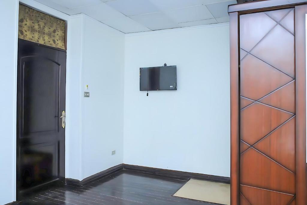 a room with a door and a tv on a wall at King palace castle hotel in Cairo