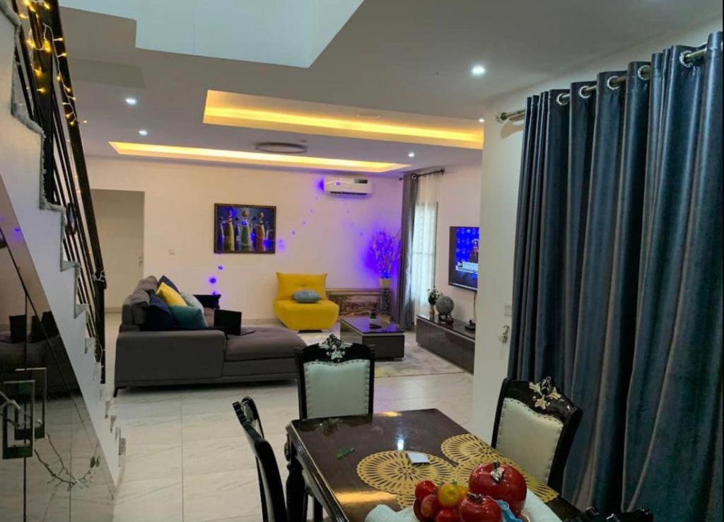 a living room with a table and a couch at Shortlet Apartment Ajah Lekki, Lagos in Lagos