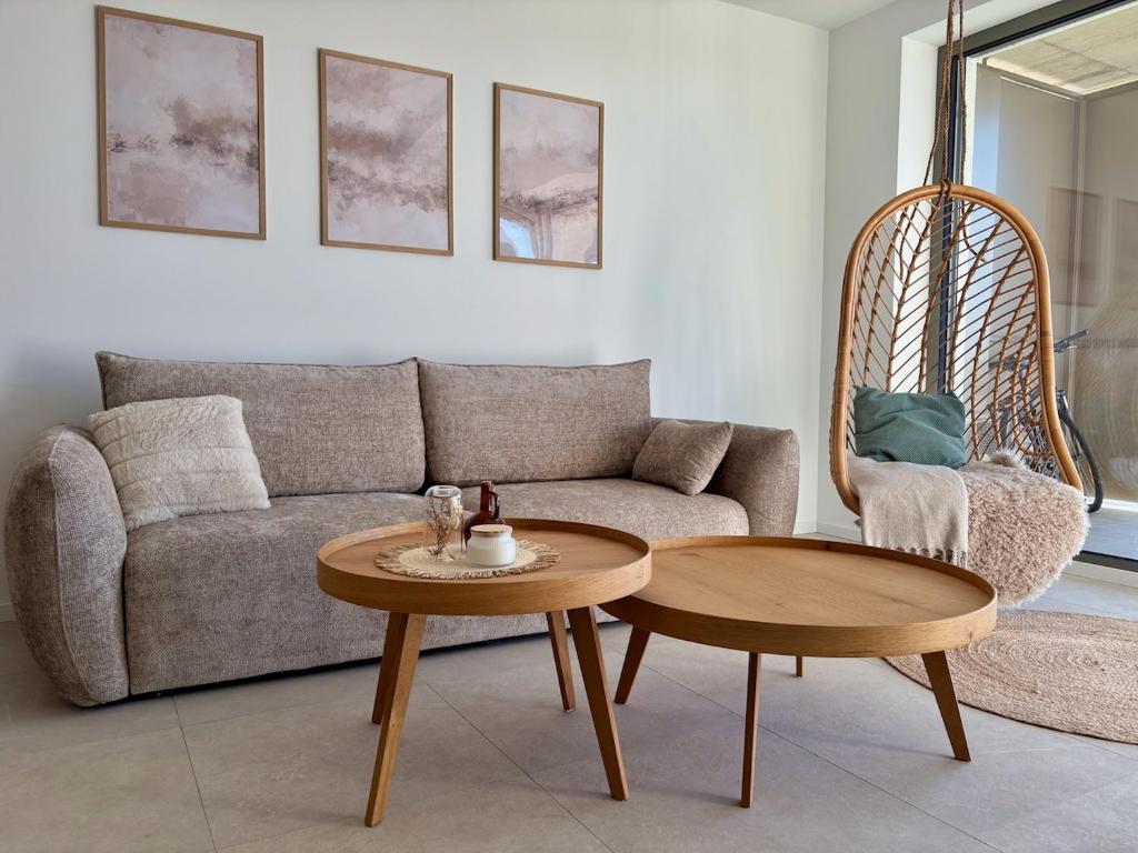 a living room with a couch and a table at Bluewave boho apartment Slnava in Banka