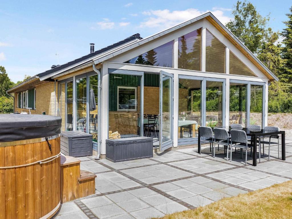 a conservatory with a table and chairs on a patio at 5 star holiday home in Vig in Hønsinge