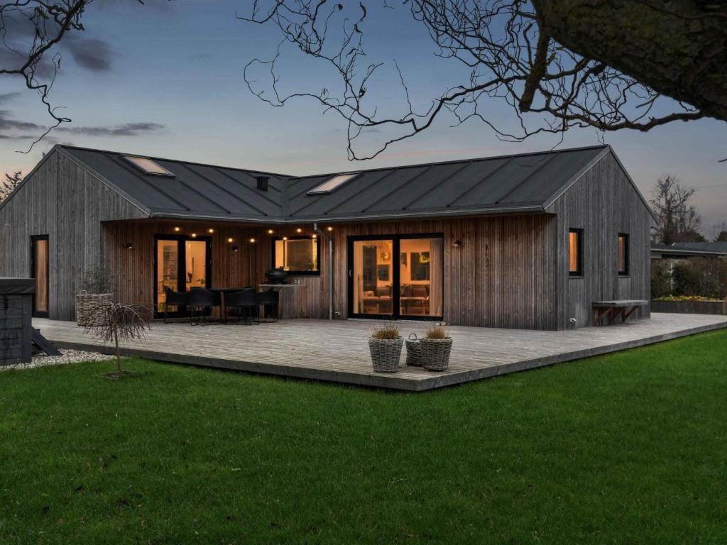 a barn style house with a patio at 5 star holiday home in Odder in Norsminde