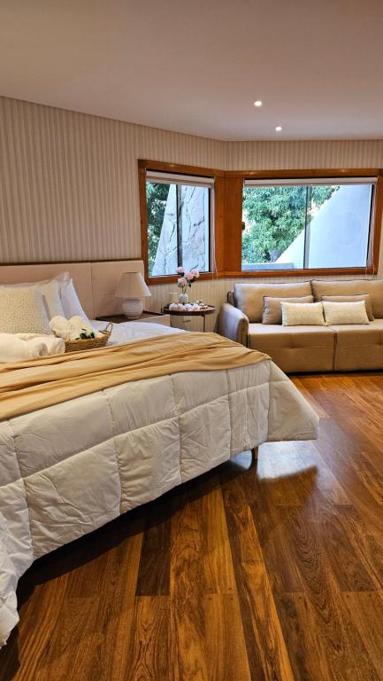 a large bedroom with a large bed and a couch at Green Palace Hotel Boutique in Asuncion