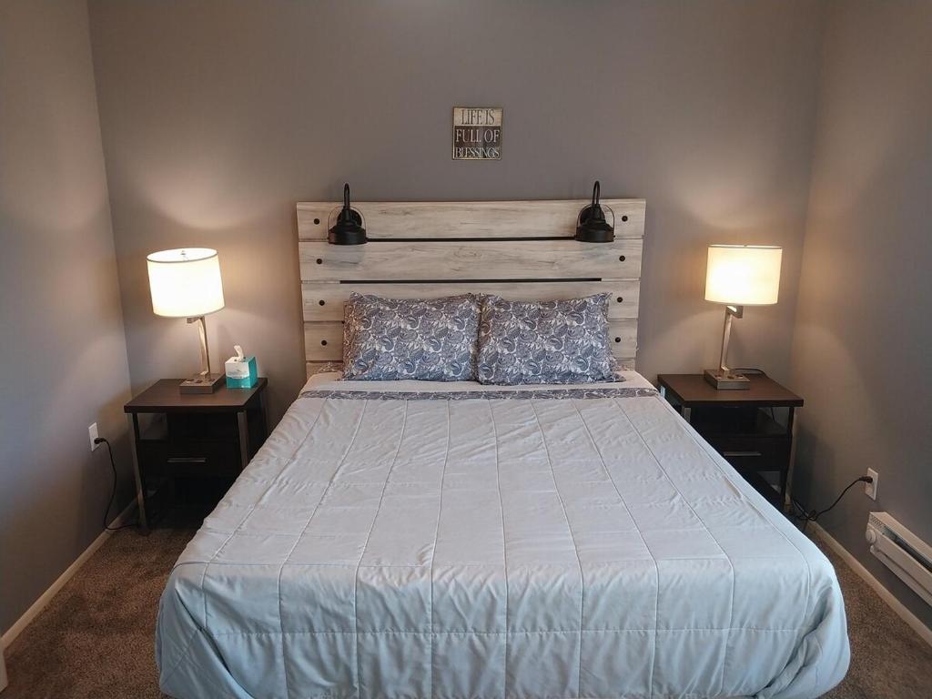 a bedroom with a bed with two lamps on two tables at Adventure Base #2 by Lake Powell in Big Water