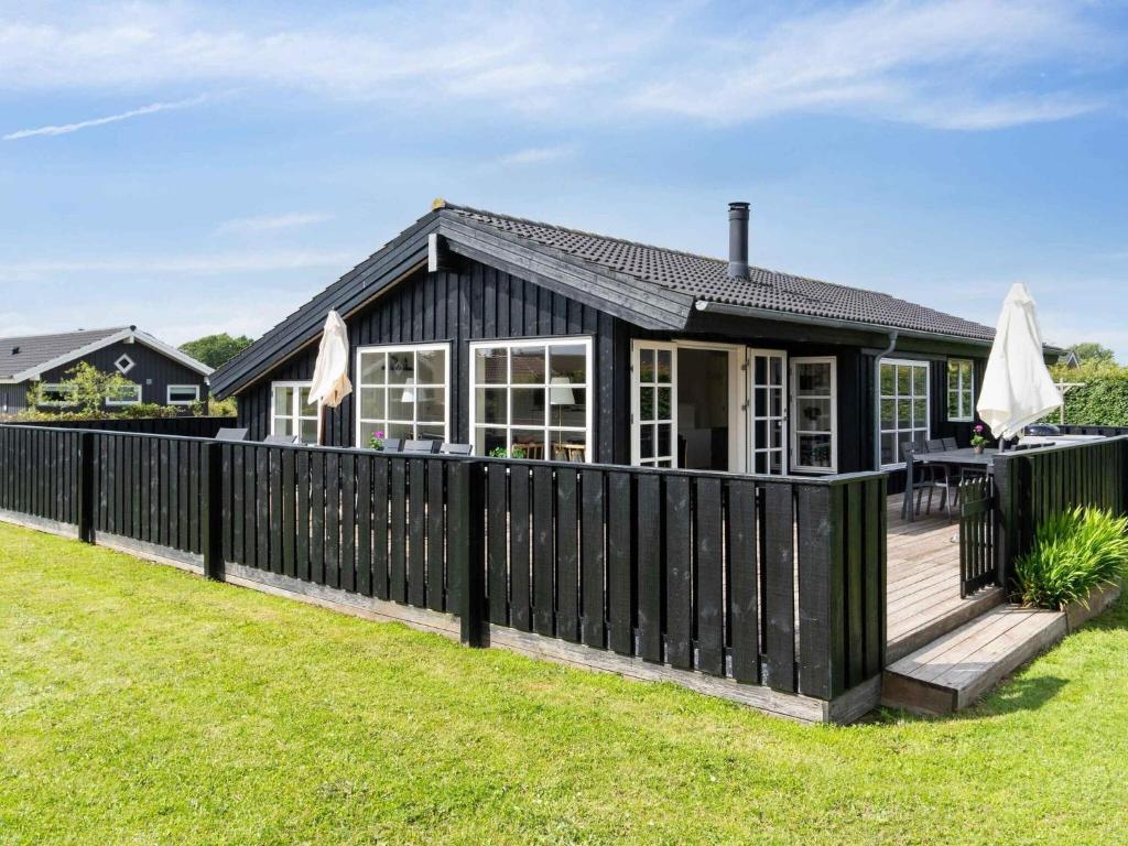 a black house with a black fence at 5 star holiday home in Haderslev in Råde