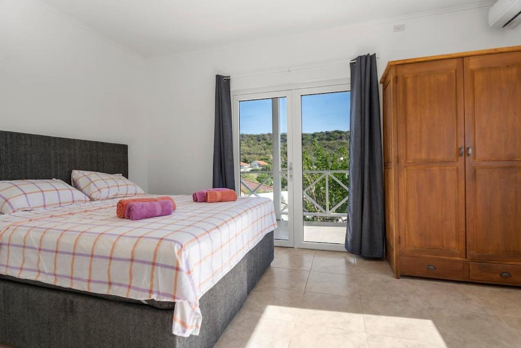 a bedroom with a bed and a sliding glass door at luxe villa met panormisch zicht en privézwembad in Fontein