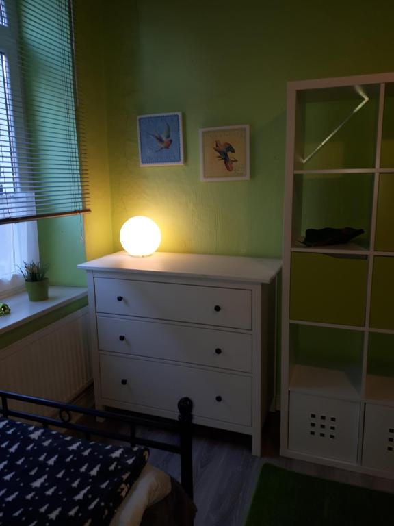 a bedroom with a dresser with a light on it at Wahlmann bed &breakfast in Hannover