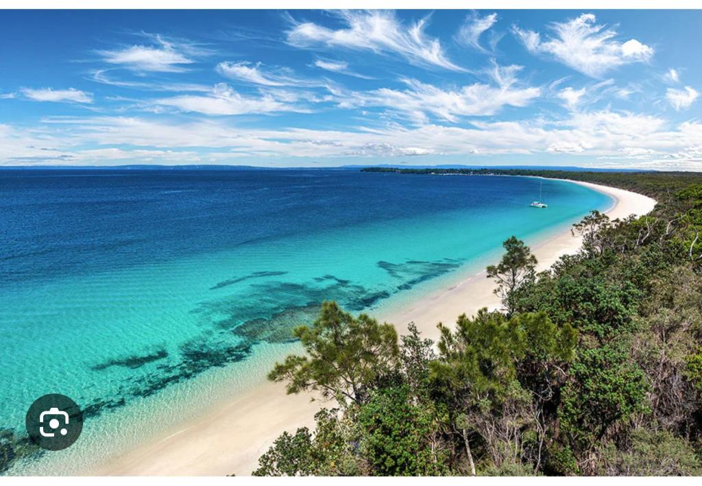 an aerial view of a beach in the ocean at Bay Breeze Cottage in Callala Bay