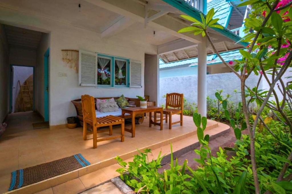 a dining room with a table and chairs on a patio at Cleosa 2 BR Cozy Bungalow Family ZN301 in Gili Air