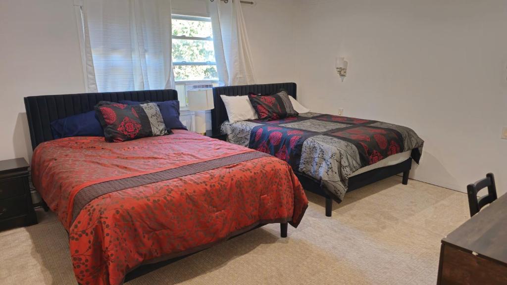 a bedroom with two beds and a window at 3 bedrooms in Deer Park