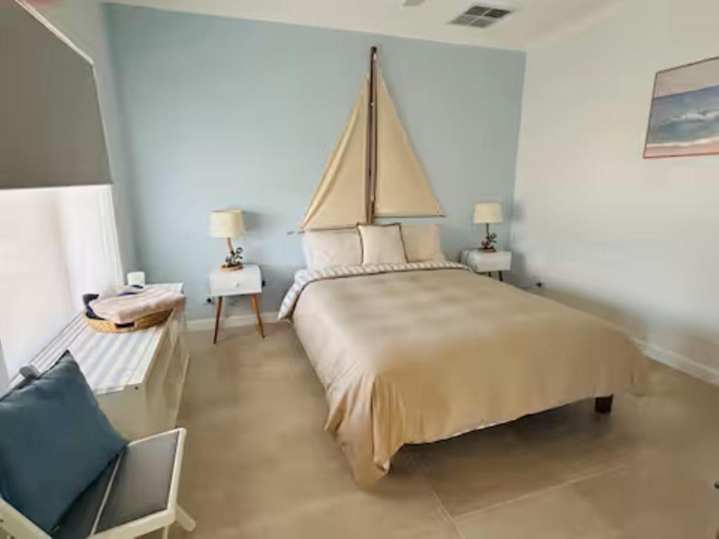 a bedroom with a large bed and a chair at Anchored at Eba in Eba Island