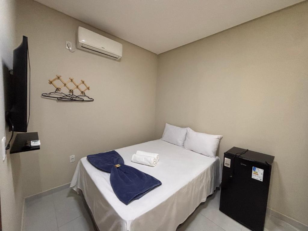 a small room with a bed and a air conditioner at Pousada Lua Bela in Piranhas