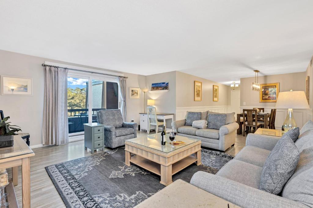a living room with two couches and a table at 889 Ketch Court in Hilton Head Island