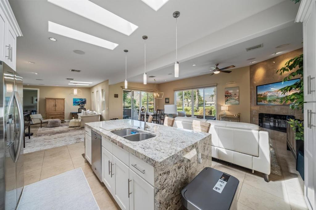 a kitchen with a sink and a living room at Chill-Inn, an Indian Wells Oasis in Indian Wells