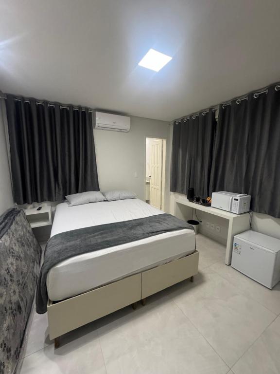 Postel nebo postele na pokoji v ubytování Loft 305B com Ar Condicionado no Bairro Muquiçaba, bem localizado para negócios e fácil acesso para todas as praias e montanhas da cidade - COM vaga de garagem