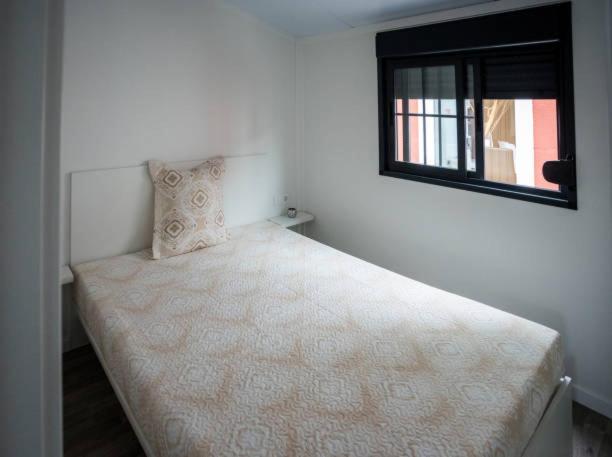 a small bedroom with a bed with a window at Khans villa in Hyderabad
