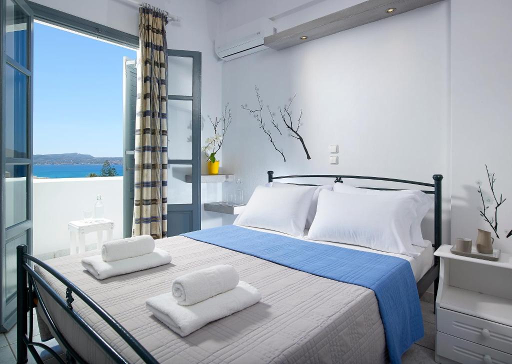 a bedroom with a bed with two towels on it at Galanis Rooms in Adamantas