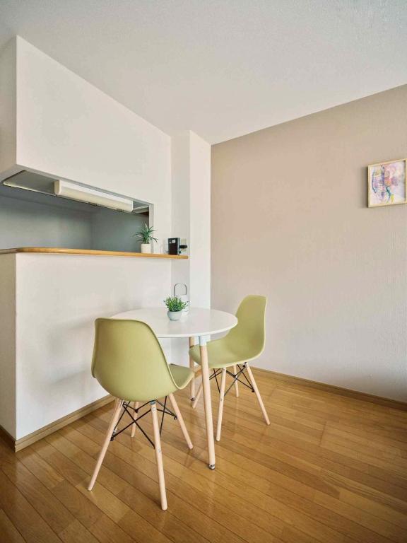 a dining room with a table and two chairs at vetta kumamoto suizenji2 204 in Kumamoto